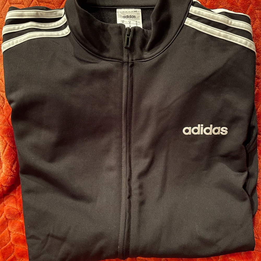 New black light weight Adidas jacket. 2 front side pockets.